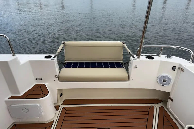  Yacht Photos Pics 2022 Ranger Tugs R-31 CB boat deck with cushioned seating and wood-style flooring.