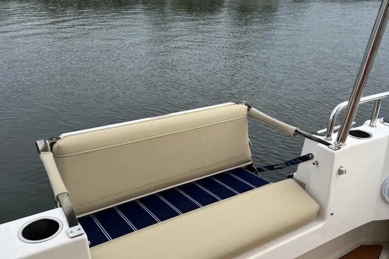  Yacht Photos Pics 2022 Ranger Tugs R-31 CB boat seat with cup holders, overlooking calm water.