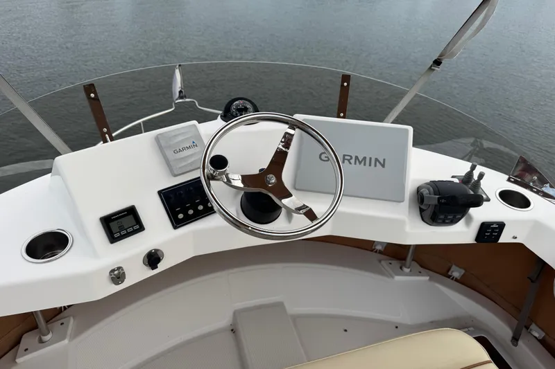  Yacht Photos Pics 2022 Ranger Tugs R-31 CB helm with Garmin navigation system and steering wheel.