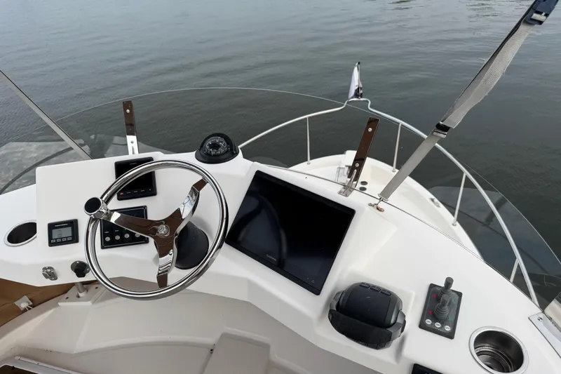  Yacht Photos Pics 2022 Ranger Tugs R-31 CB helm with steering wheel, controls, and navigation display.