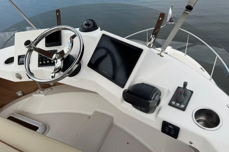  Yacht Photos Pics Helm of 2022 Ranger Tugs R-31 CB with steering wheel and navigation controls.