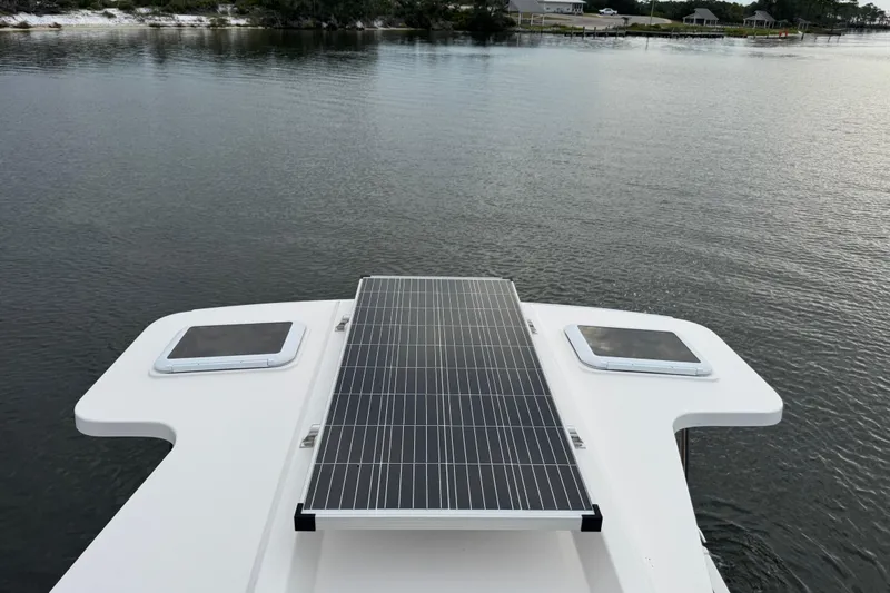  Yacht Photos Pics 2022 Ranger Tugs R-31 CB with solar panel on deck, overlooking calm water.