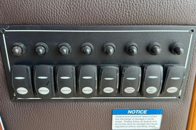  Yacht Photos Pics Control panel of 2022 Ranger Tugs R-31 CB with labeled switches for various functions.