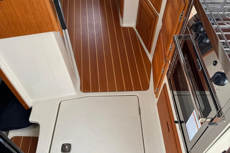  Yacht Photos Pics Interior of 2022 Ranger Tugs R-31 CB with wood flooring and modern kitchen appliances.