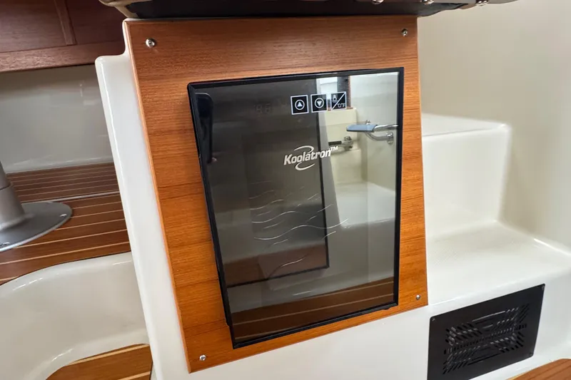  Yacht Photos Pics Koolatron fridge in 2022 Ranger Tugs R-31 CB boat interior, featuring wood paneling.