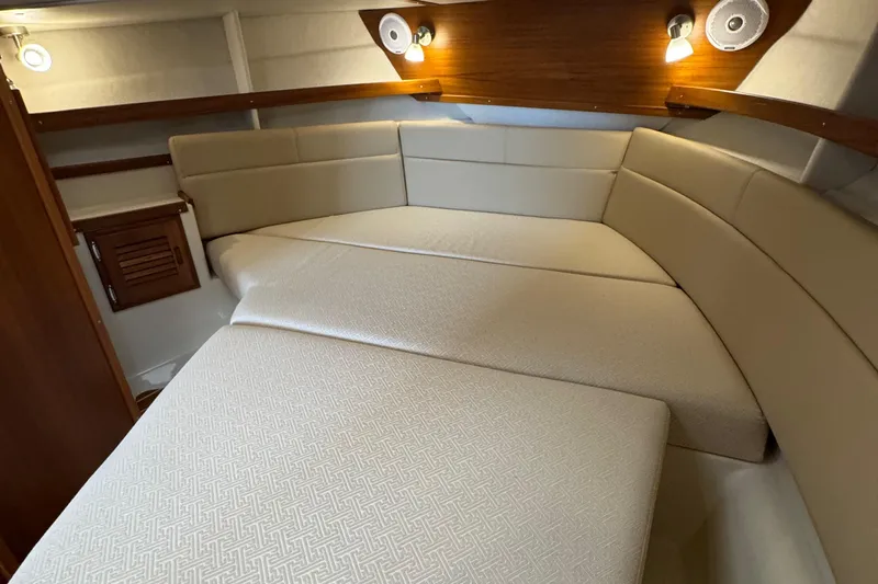  Yacht Photos Pics 2022 Ranger Tugs R-31 CB cabin interior with beige upholstery and wooden accents.
