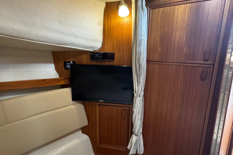  Yacht Photos Pics Interior of 2022 Ranger Tugs R-31 CB with TV, wood paneling, and ambient lighting.