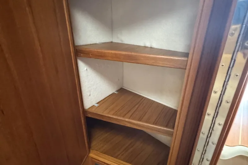  Yacht Photos Pics Wooden shelving inside a Ranger Tugs R-31 CB, 2022 model, showcasing storage space.