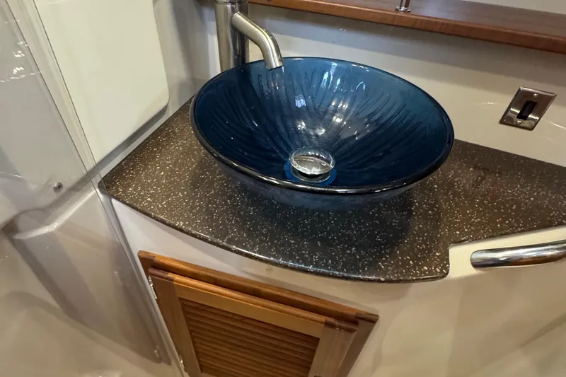  Yacht Photos Pics Luxurious blue glass sink in 2022 Ranger Tugs R-31 CB boat bathroom.