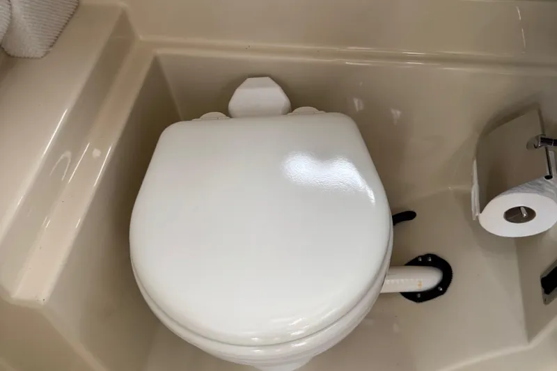  Yacht Photos Pics 2022 Ranger Tugs R-31 CB boat bathroom with toilet and toilet paper holder.