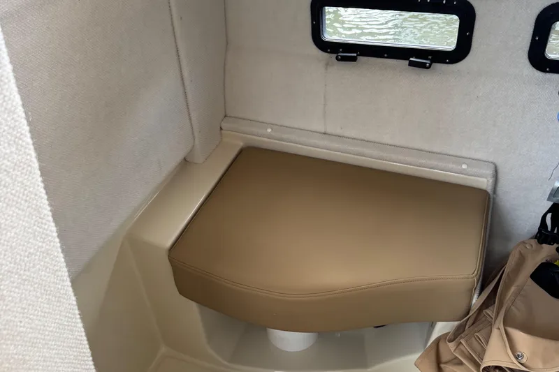  Yacht Photos Pics 2022 Ranger Tugs R-31 CB interior cabin with cushioned seating and small windows.