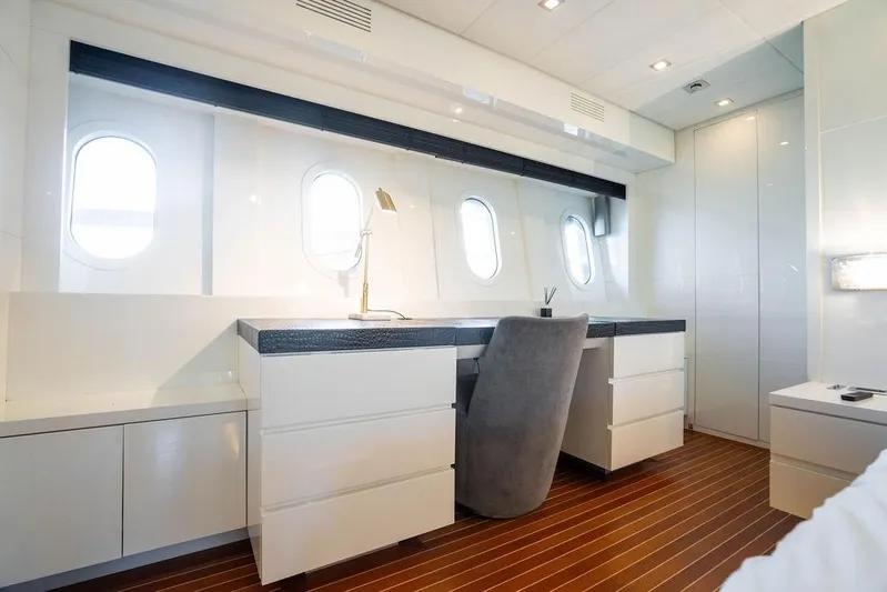 Venture Yacht Photos Pics Luxurious yacht interior with sleek desk, modern chair, and porthole windows on Arno Leopard 31.