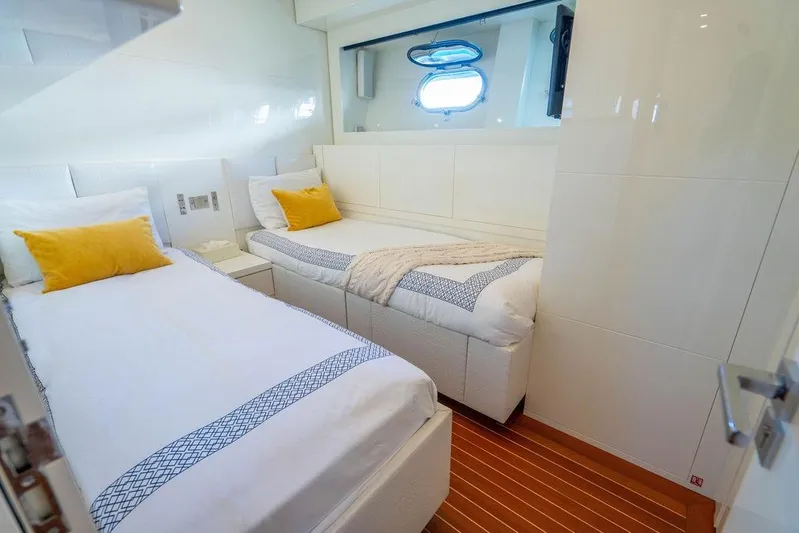 Venture Yacht Photos Pics Luxurious twin cabin on 2007 Arno Leopard 31 yacht with elegant bedding and porthole view.