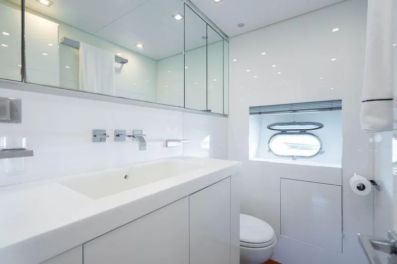 Venture Yacht Photos Pics Luxurious yacht bathroom with modern fixtures, white decor, and a porthole window. Arno Leopard 31, 2007.