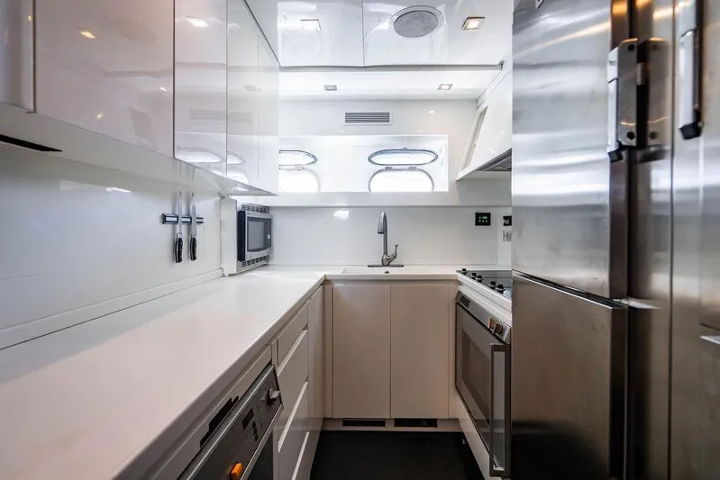 Venture Yacht Photos Pics Modern yacht kitchen with sleek white cabinetry, stainless steel appliances, and ample counter space. Arno Leopard 31, 2007.