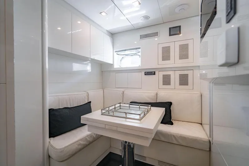 Venture Yacht Photos Pics Luxurious white interior of 2007 Arno Leopard 31 yacht with modern seating and table.