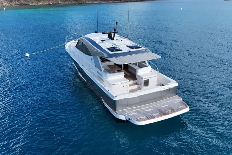  Yacht Photos Pics 2026 Riviera 505 SUV yacht on serene blue waters, showcasing sleek design and luxury features.