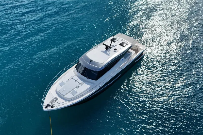  Yacht Photos Pics 2026 Riviera 505 SUV yacht on sparkling blue water, aerial view.