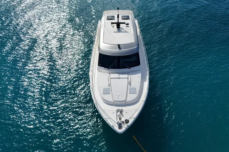  Yacht Photos Pics Aerial view of 2026 Riviera 505 SUV yacht on sparkling blue water.