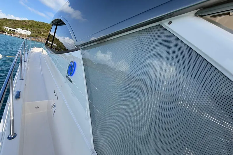  Yacht Photos Pics 2026 Riviera 505 SUV yacht side view, sleek design, docked in scenic waters.