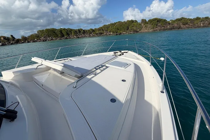  Yacht Photos Pics 2026 Riviera 505 SUV yacht deck with scenic ocean view and lush island backdrop.