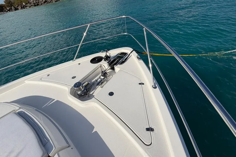  Yacht Photos Pics Bow of 2026 Riviera 505 SUV yacht on clear blue water.