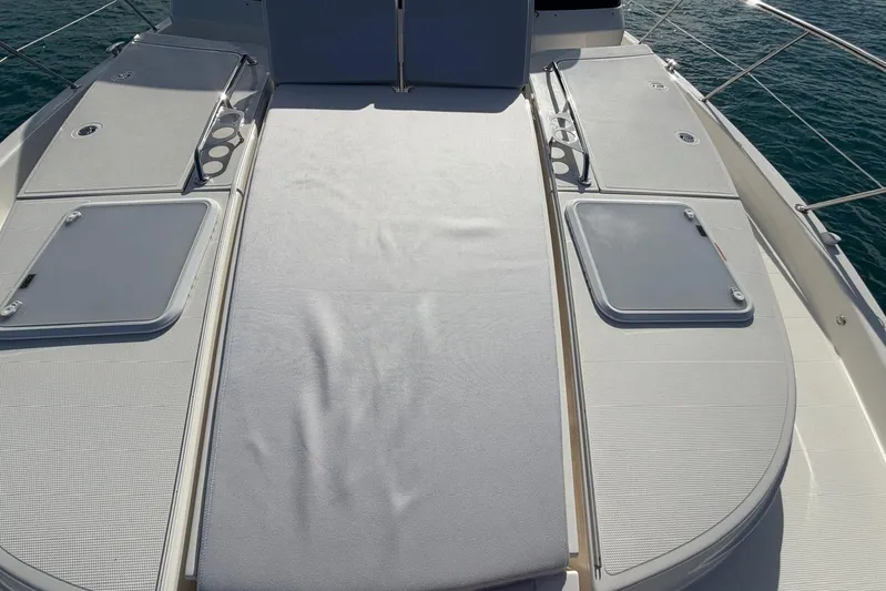  Yacht Photos Pics 2026 Riviera 505 SUV yacht deck with sunbathing area and storage hatches.