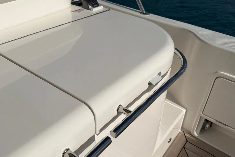  Yacht Photos Pics Riviera 505 SUV 2026 yacht deck detail with sleek white finish and chrome railing.