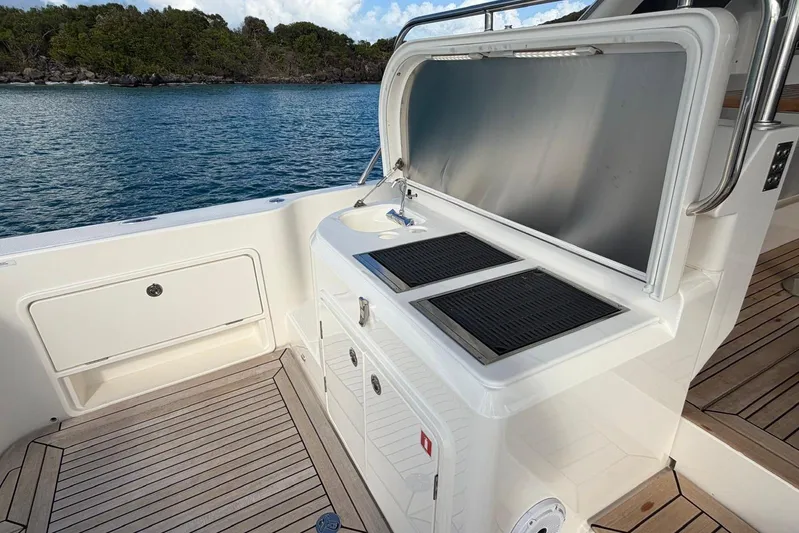  Yacht Photos Pics Outdoor kitchen on 2026 Riviera 505 SUV yacht with scenic ocean view.