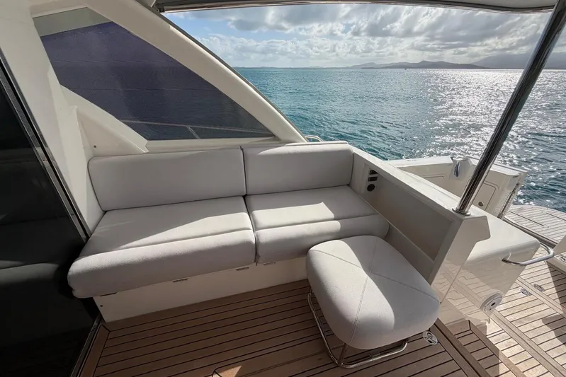  Yacht Photos Pics Luxurious seating on 2026 Riviera 505 SUV yacht, overlooking serene ocean waters.