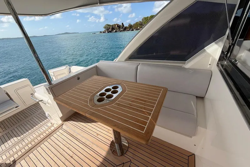  Yacht Photos Pics Luxurious 2026 Riviera 505 SUV yacht deck with elegant seating and ocean view.