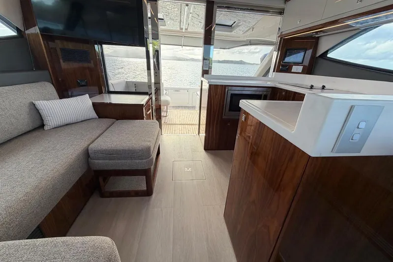  Yacht Photos Pics Luxurious interior of 2026 Riviera 505 SUV yacht with modern furnishings and scenic ocean view.