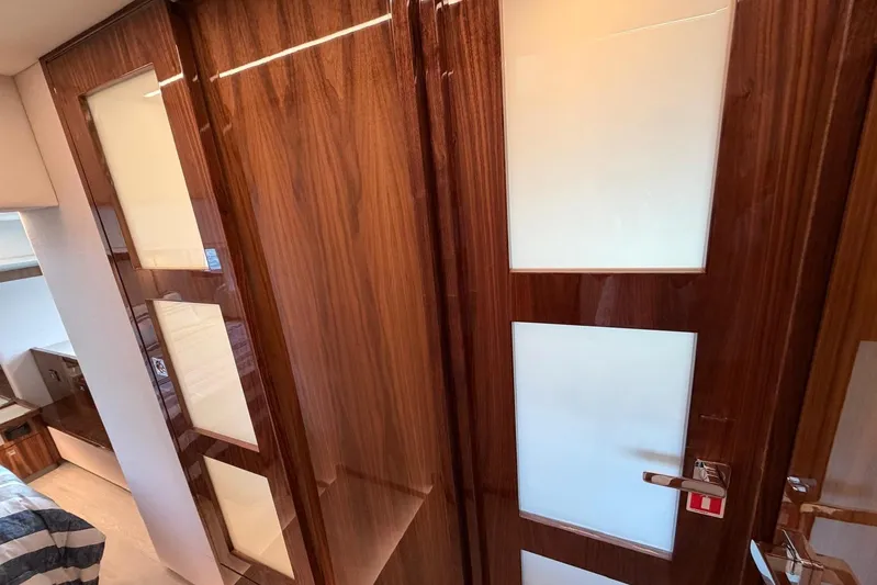  Yacht Photos Pics Luxurious interior of 2026 Riviera 505 SUV with sleek wooden cabinetry and modern design.