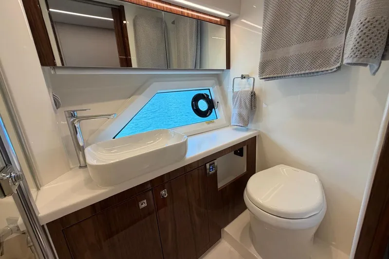  Yacht Photos Pics Luxurious bathroom in 2026 Riviera 505 SUV yacht with modern fixtures and ocean view.