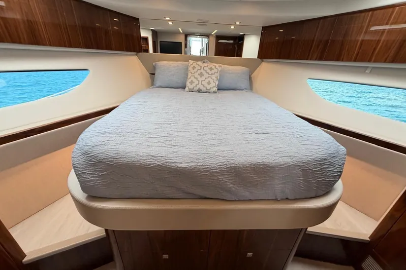  Yacht Photos Pics Luxurious bedroom interior of 2026 Riviera 505 SUV yacht with ocean view.