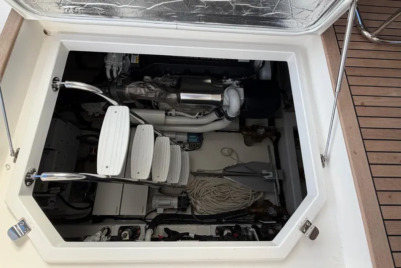  Yacht Photos Pics Engine compartment of 2026 Riviera 505 SUV yacht, showcasing mechanical components and storage.