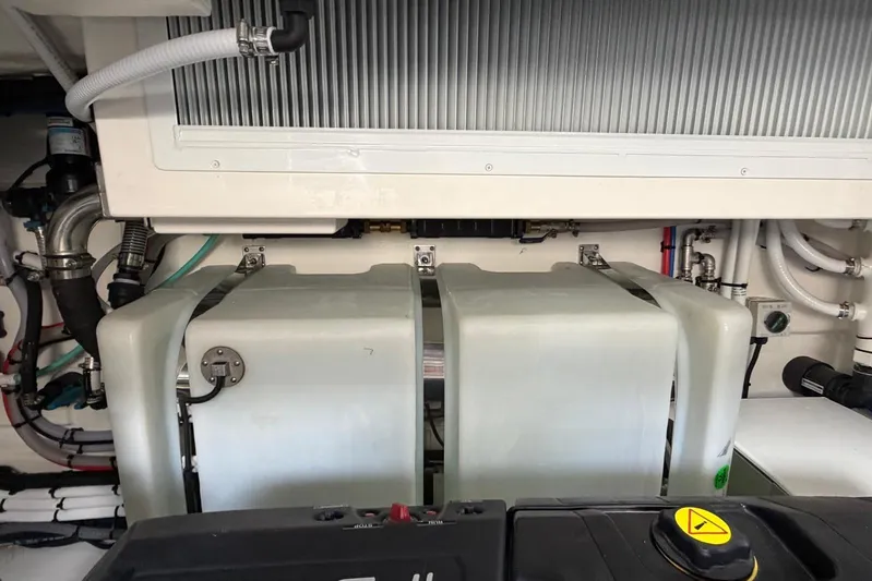  Yacht Photos Pics Engine room of 2026 Riviera 505 SUV with visible components and piping.