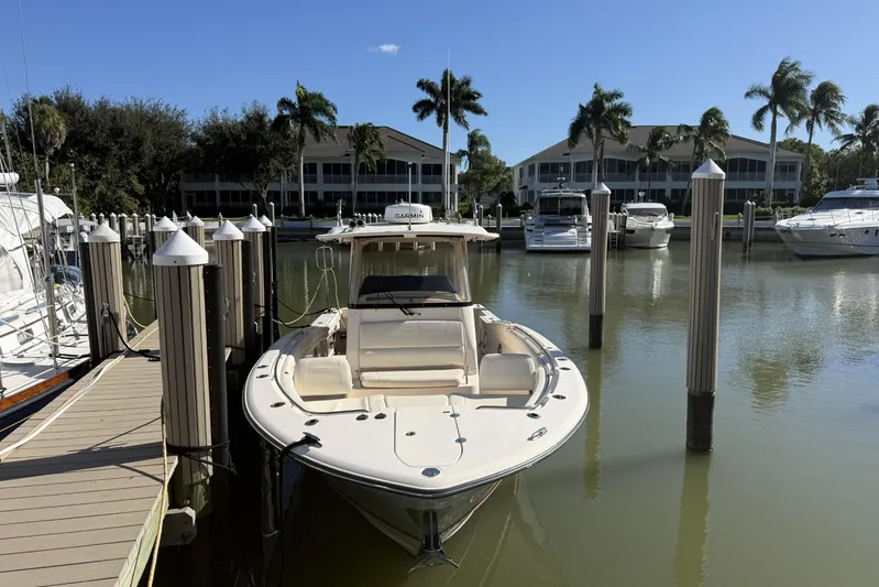  Yacht Photos Pics 2020 Grady-White Canyon 326 boat docked in a marina with palm trees.