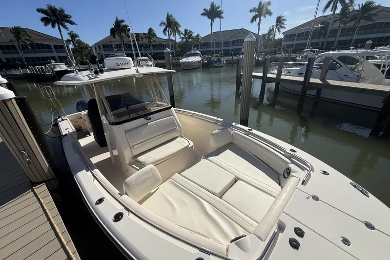  Yacht Photos Pics 2020 Grady-White Canyon 326 boat docked in a marina with palm trees.
