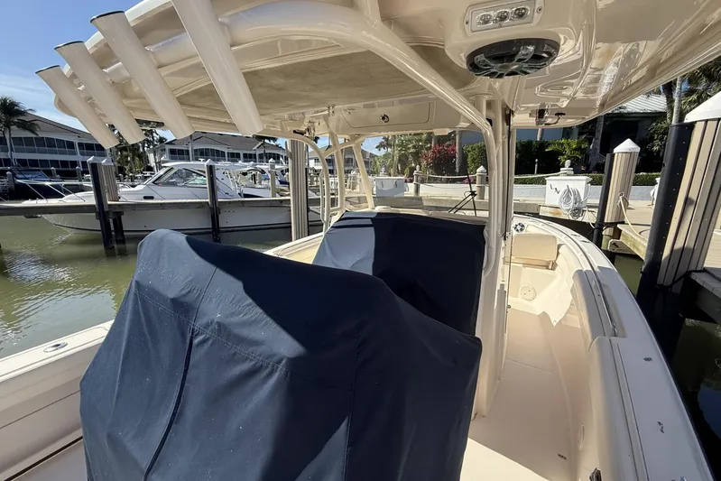  Yacht Photos Pics 2020 Grady-White Canyon 326 boat docked, featuring covered seating and rod holders.