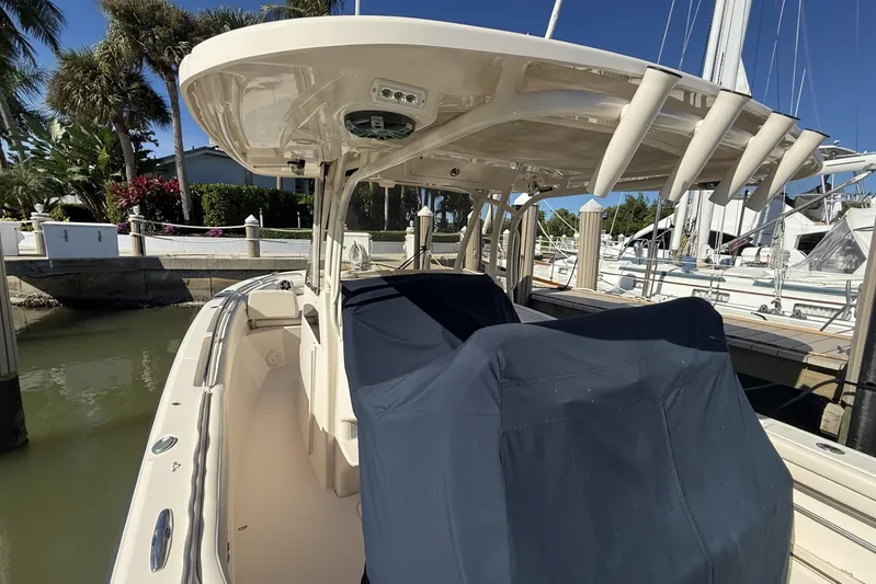  Yacht Photos Pics 2020 Grady-White Canyon 326 boat docked, featuring covered seating and rod holders.