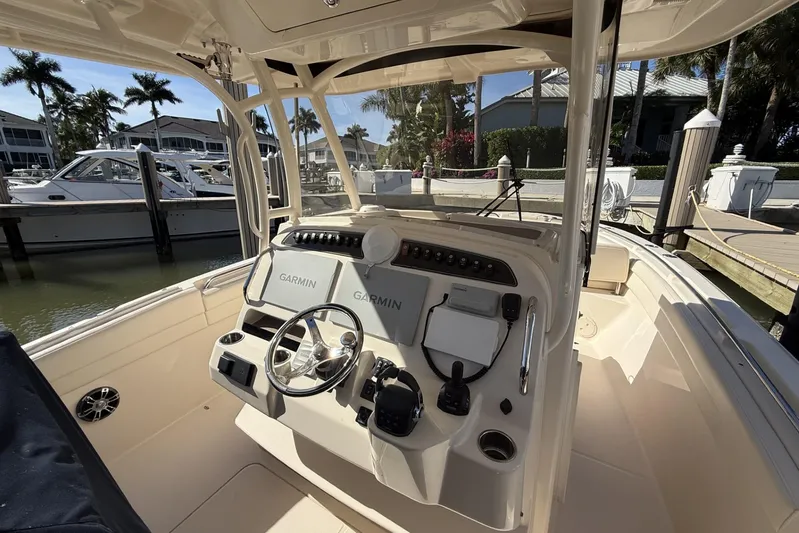  Yacht Photos Pics 2020 Grady-White Canyon 326 boat helm with Garmin navigation, docked in a marina.