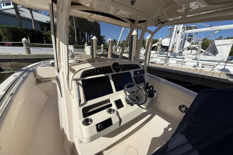  Yacht Photos Pics 2020 Grady-White Canyon 326 boat cockpit with steering wheel and control panel.
