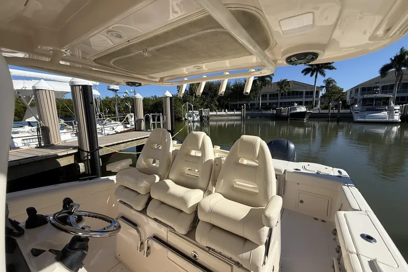  Yacht Photos Pics 2020 Grady-White Canyon 326 boat interior with helm seats at marina.