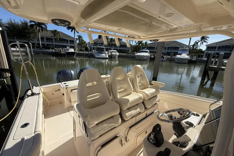  Yacht Photos Pics 2020 Grady-White Canyon 326 boat interior with helm and seating, docked at marina.