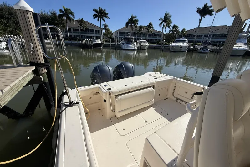  Yacht Photos Pics 2020 Grady-White Canyon 326 boat docked in a marina with palm trees.