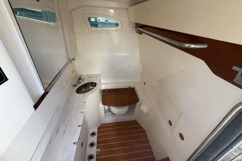  Yacht Photos Pics 2020 Grady-White Canyon 326 boat interior with sink and wooden accents.