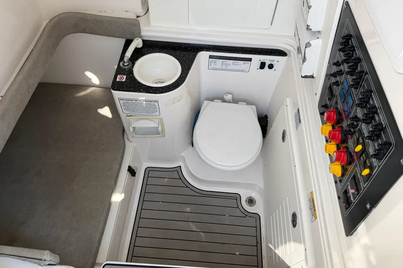  Yacht Photos Pics 2020 Sea Fox 328 Commander boat interior with toilet, sink, and control panel.