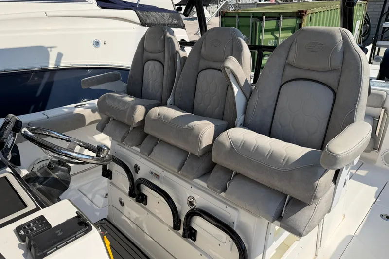  Yacht Photos Pics 2020 Sea Fox 328 Commander boat interior with three cushioned seats and steering wheel.