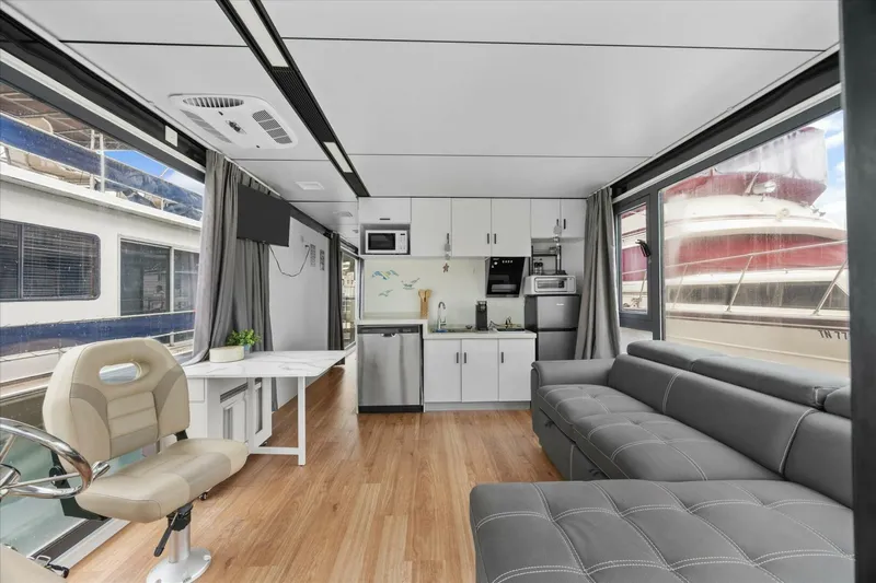  Yacht Photos Pics Modern houseboat interior with kitchen, sofa, and helm; Gospel 39, 2024 model.